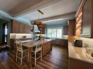 Beautiful kitchen remodel with wooden cabinets, large island, and modern lighting by KC's Improvement & Construction Co., Inc. in Greensboro, NC