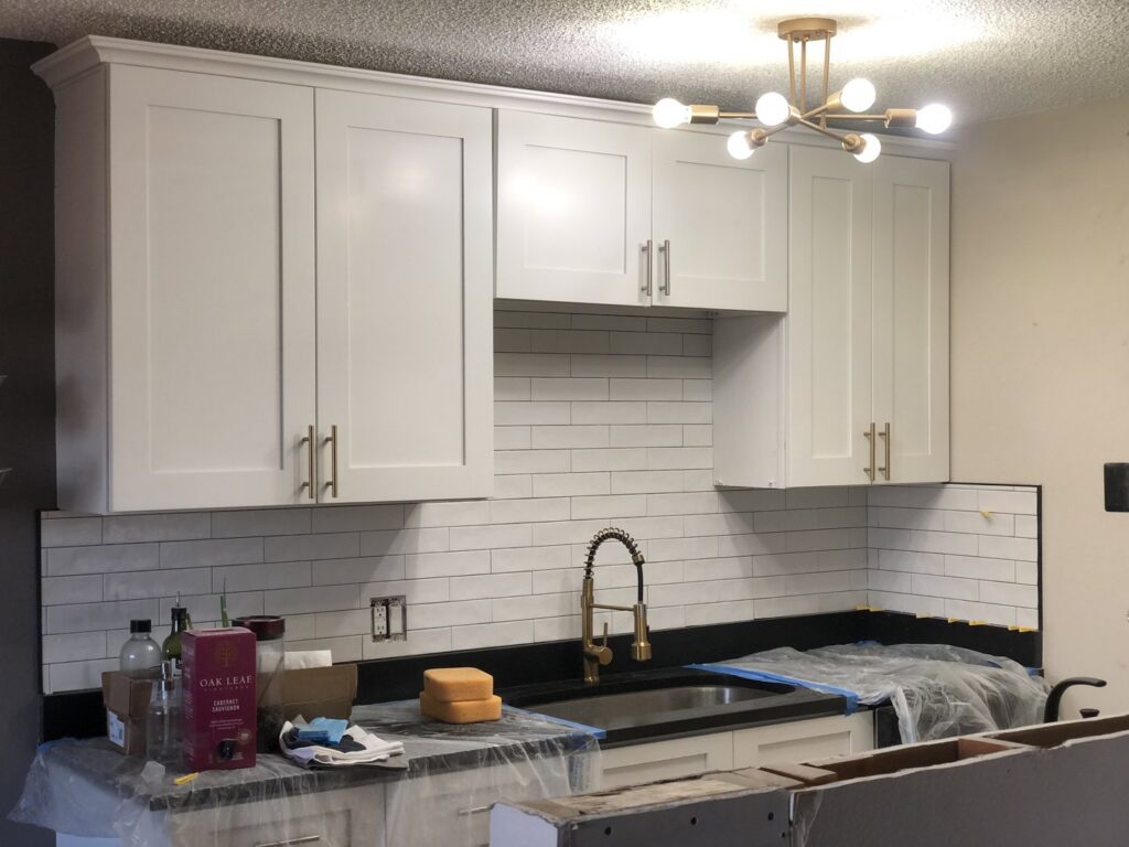 Kitchen renovation with new cabinets and subway tile backsplash by Denver House Repair in Lakewood, CO.