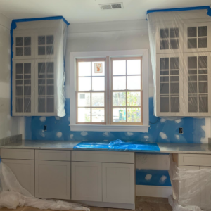 Kitchen renovation in progress with installed cabinets, protected countertops, and walls prepped for painting by Mike Murphy Builders, LLC in Memphis, TN.