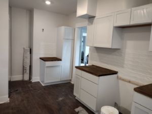 A kitchen renovation project showing new white cabinets and subway tile backsplash by I.B. Remodeling LLC in Dayton, OH.