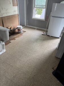 A kitchen floor with renovation debris and appliances, ready for cleanup by Junk Removal Brothers in Worcester, MA.