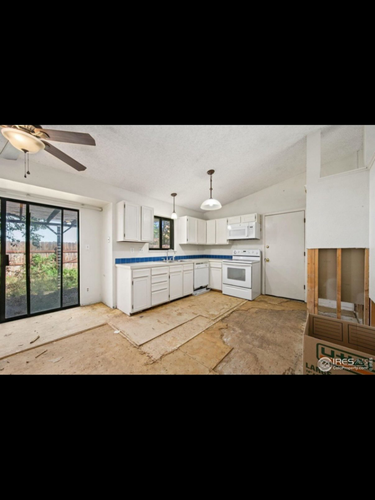 Kitchen renovation with torn-up flooring and exposed wall studs, handyman demolition services by Radiant Homes LLC in Denver, CO.