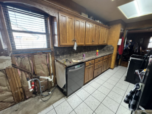 Kitchen renovation showing exposed plumbing and insulation near a dishwasher by JM Renovations LLC in Moore, OK.