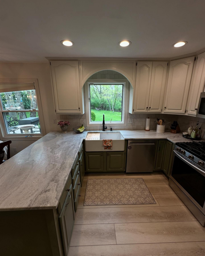 Completed kitchen renovation with farmhouse sink and new countertops by True North Builders in Franktown, CO.
