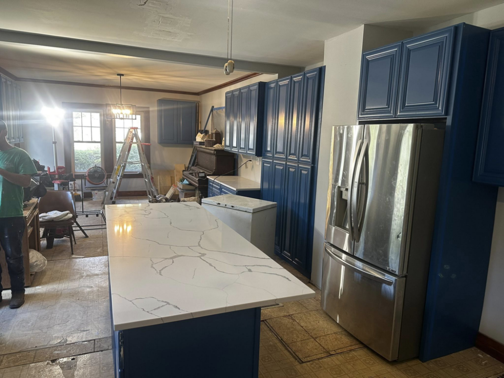 A kitchen renovation in progress with new blue cabinets and a white island by Affordable Home Solutions in Springfield, PA.