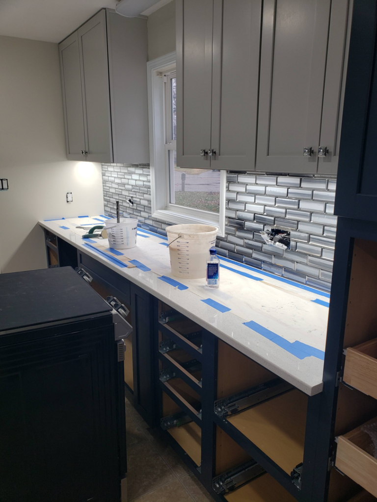 Kitchen renovation in progress, showing new cabinets, countertops, and backsplash tiling by BEST QUALITY CONSTRUCTION COMPANY in Fountain Valley, CA.