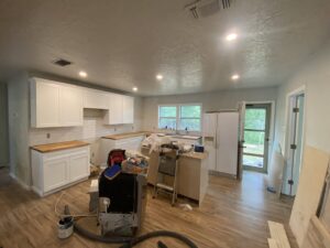 A kitchen renovation in progress, showing new cabinets, countertops, and appliances installed by Elite Handyman & Remodeling in Dallas, TX.