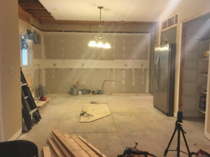 A kitchen undergoing renovation with walls open and construction materials, handled by EMR Contracting, LLC in Linden, NJ