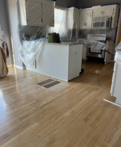 Kitchen renovation in progress with cabinets covered and floor samples visible by crystalwoodfloors in Port Jervis, NY