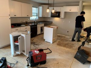 A kitchen renovation in progress with new cabinets installed and subfloor exposed, managed by Lancaster Home Builders in Lancaster, PA.