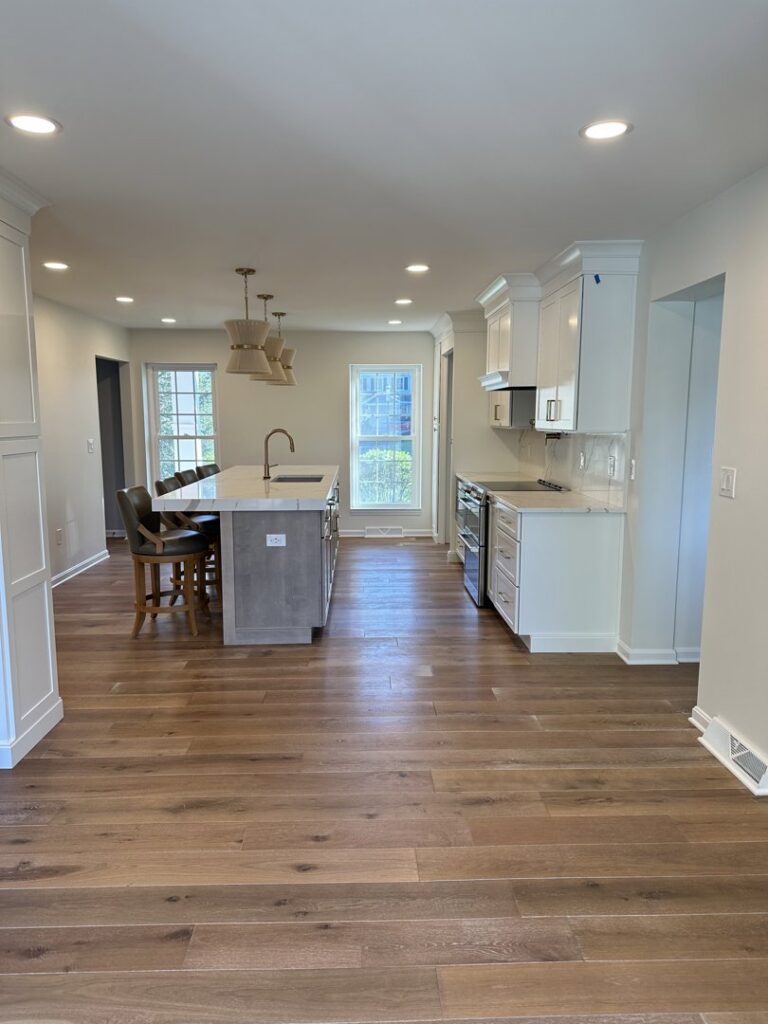 A kitchen renovation in progress, showing new white cabinets and quartz countertops being installed by Legacy Builders Group in Cincinnati, OH.
