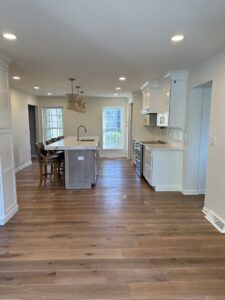 A kitchen renovation in progress, showing new white cabinets and quartz countertops being installed by Legacy Builders Group in Cincinnati, OH.