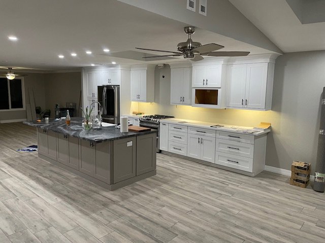 A kitchen renovation in progress with new cabinets and an island being installed by MGD Builders in Phoenix, AZ.