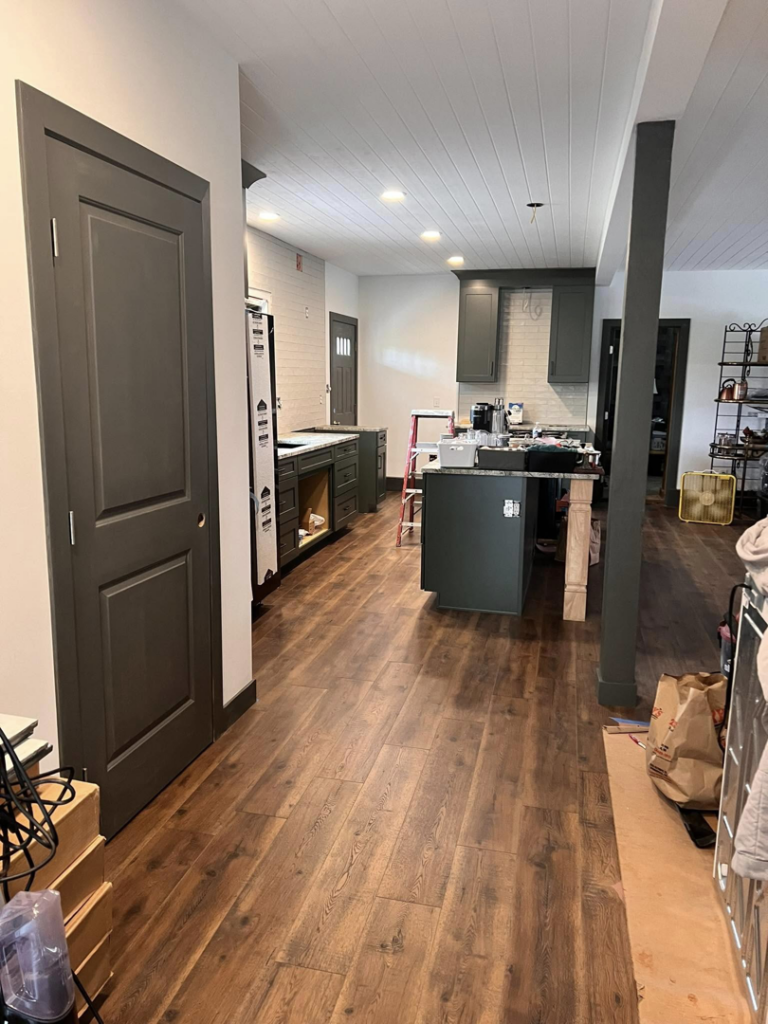 An interior kitchen renovation in progress, showing new cabinets and a ladder by One Up construction llc in Springfield, OR.