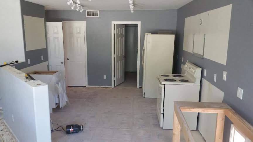 A kitchen undergoing renovation with cabinets removed by Priority One Home Repair LLC in Glendale, AZ
