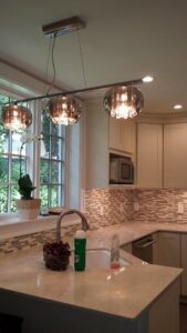 A newly renovated kitchen featuring new cabinets, countertops, and modern lighting by Mendez Contractor Inc in Lynn, MA