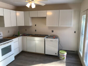 A kitchen renovation in progress with new white cabinets installed by Carl Gardner Contracting in Syracuse, NY.