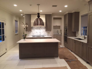 A kitchen undergoing renovation with protective floor covering, showcasing handyman services by Northshore Custom Homes in Covington, LA.