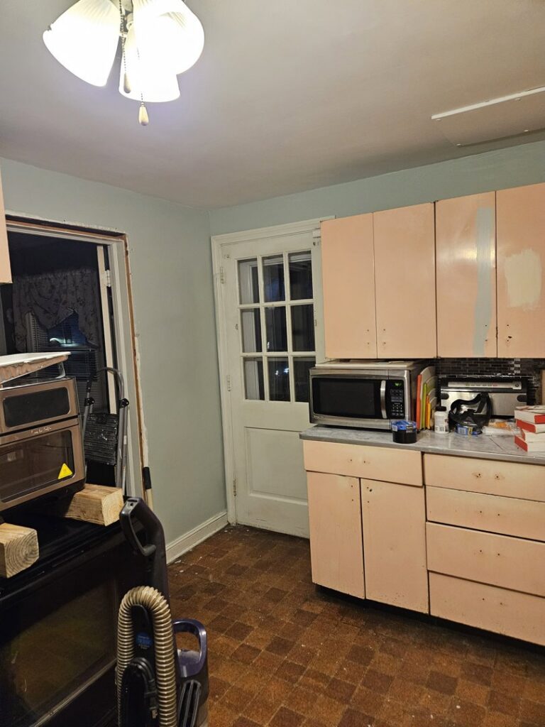 A kitchen undergoing renovation with cabinets and appliances, showcasing handyman services by AA Asbestos Abatement, LLC in Portland, CT.