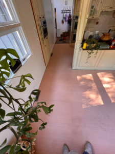 A kitchen renovation in progress, showing new subfloor installed and existing cabinets, by Bryder Construction in Greenville, SC.