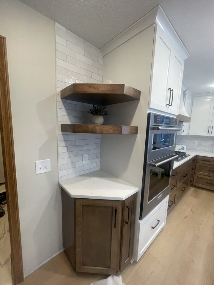 A newly renovated kitchen corner with subway tile backsplash and custom cabinets installed by K&T PRO Painting in St. Cloud, MN.