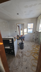 Kitchen renovation showing tools, saw, and drywall work by Clausen Construction LLC in Williston, ND