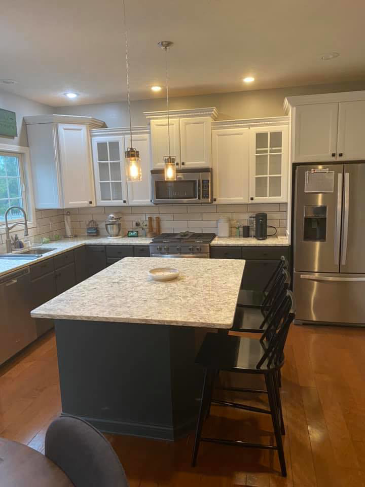A newly renovated kitchen featuring two-tone cabinets and a new island by Shawn's Handyman Services in Fishers, IN.