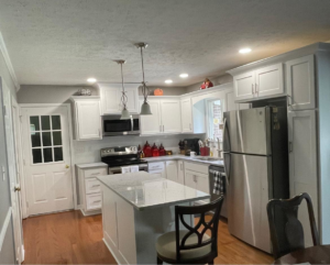 Completed kitchen renovation with white cabinets, a light island, and stainless steel appliances by Blue Ribbon Renovations in Elizabethtown, KY.
