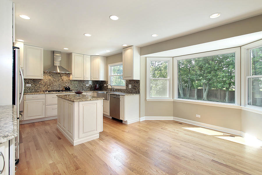 A bright kitchen renovation featuring white cabinets and a bay window by Indy Renovation in Indianapolis, IN.