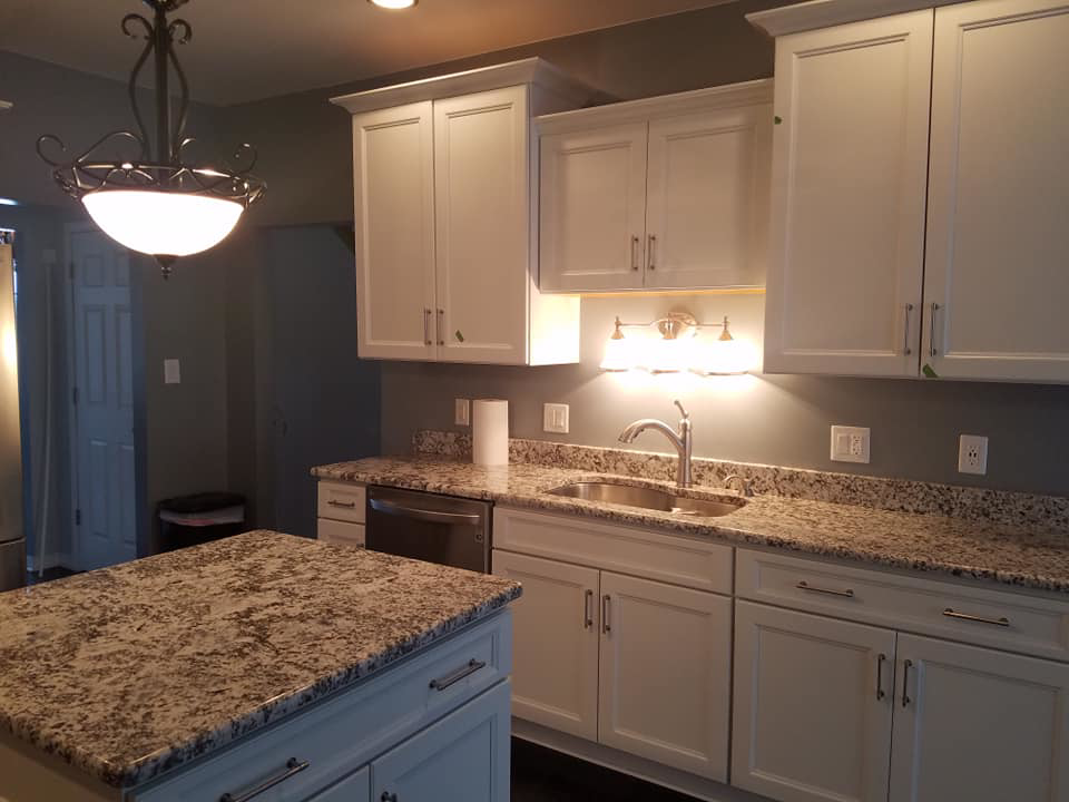 Newly installed kitchen sink, white cabinets, and granite countertops by Land Bank Builders and Associates in Gary, IN