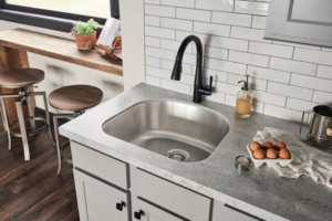 A newly installed kitchen sink, black faucet, and subway tile backsplash by Preferred Millworks & Design in Edmond, OK.
