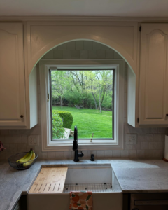 Close-up of a kitchen sink with new faucet and subway tile backsplash by True North Builders in Franktown, CO.
