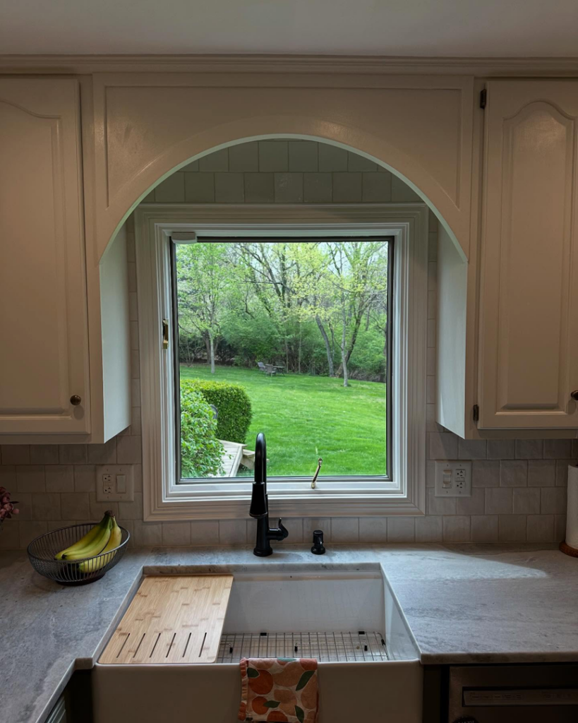 Close-up of a kitchen sink with new faucet and subway tile backsplash by True North Builders in Franktown, CO.