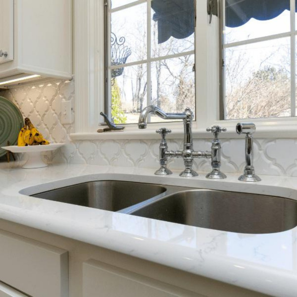 A newly installed kitchen sink and faucet with a white tile backsplash by Louisville Handyman & Remodeling in Louisville, KY.