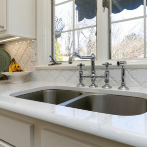 A newly installed kitchen sink and faucet with a white tile backsplash by Louisville Handyman & Remodeling in Louisville, KY.