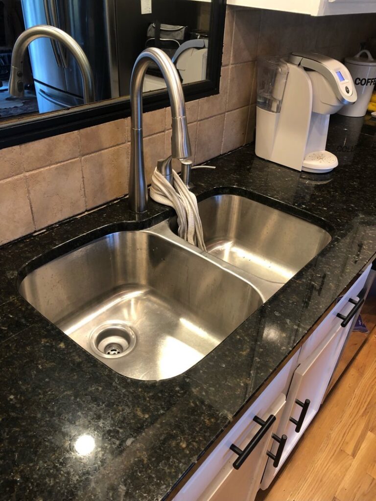 Double basin kitchen sink with new gooseneck faucet installed by True North Builders in Franktown, CO.