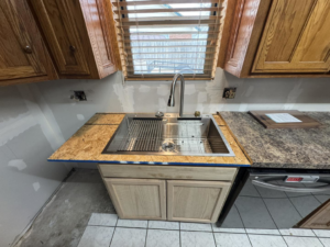A newly installed kitchen sink and faucet during a renovation project by JM Renovations LLC in Moore, OK.