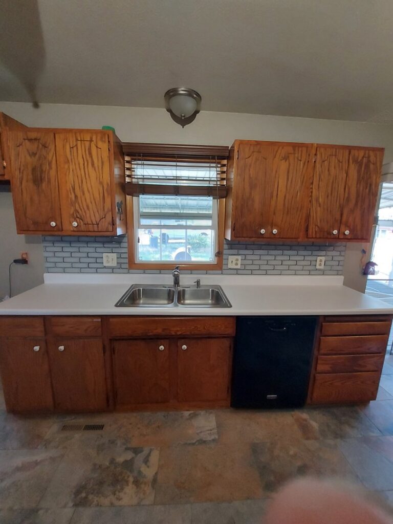 Kitchen with newly installed tile backsplash and floor by True Alchemy - Tile & Grout Restoration in Denver, CO.