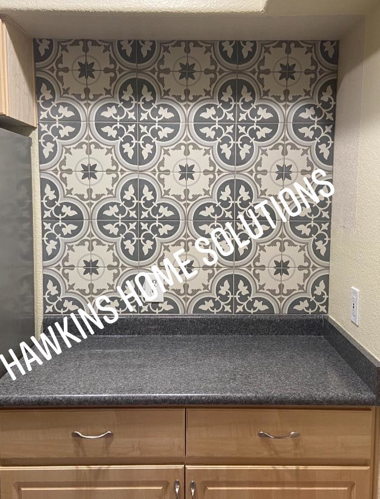 A newly installed decorative tile backsplash in a kitchen by Hawkins Home Solutions in Glendale, AZ.