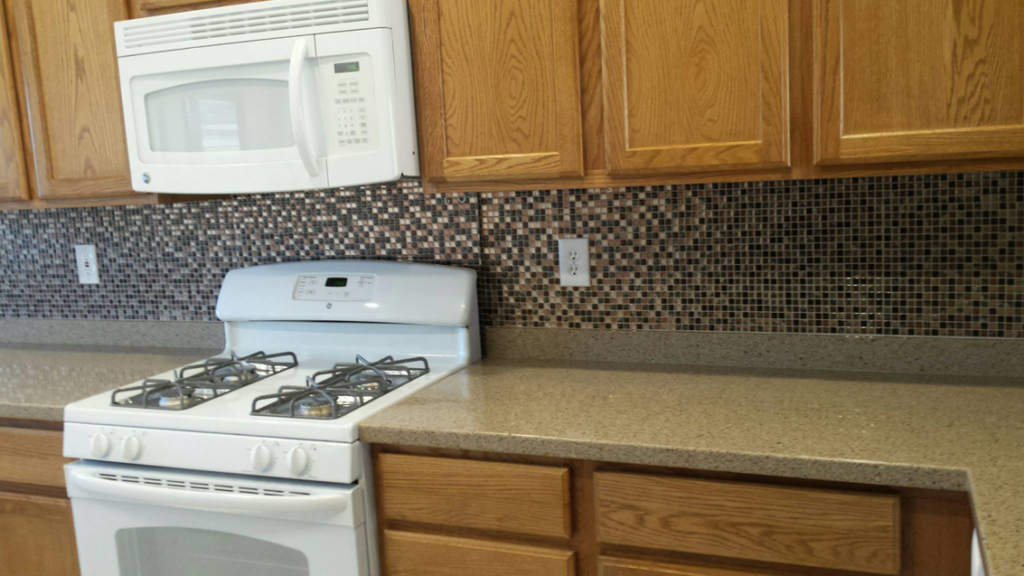 A newly installed tile backsplash in a kitchen, a service provided by We Can Do It Complete Handyman Services in Henderson, NV.