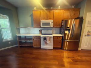 A kitchen update featuring new countertops, subway tile backsplash, and custom shelving by Tanner Custom Carpentry in Loveland, CO.
