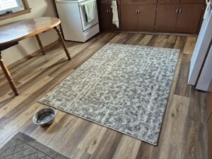 Kitchen with newly installed vinyl plank flooring and a decorative rug by D E Custom Floors in Waukesha, WI.
