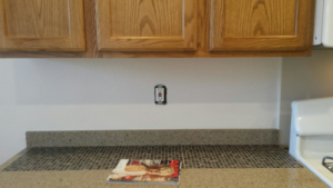 A kitchen wall and countertop before tile backsplash installation by We Can Do It Complete Handyman Services in Henderson, NV.