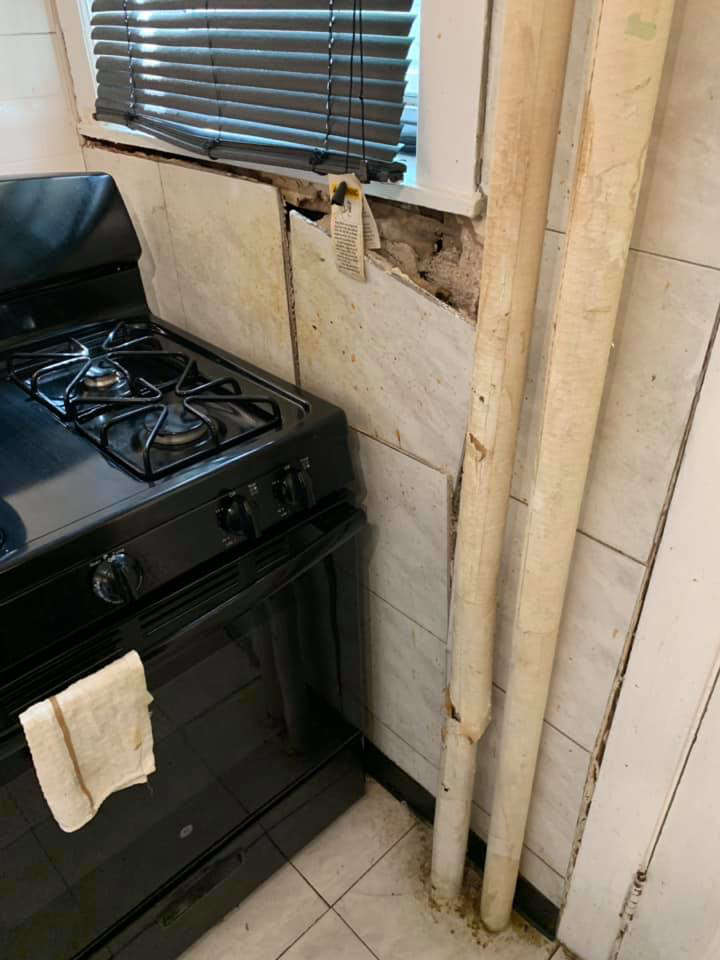 Kitchen wall demolition in progress showing exposed wall by Tawfiq Services LLC in Philadelphia, PA