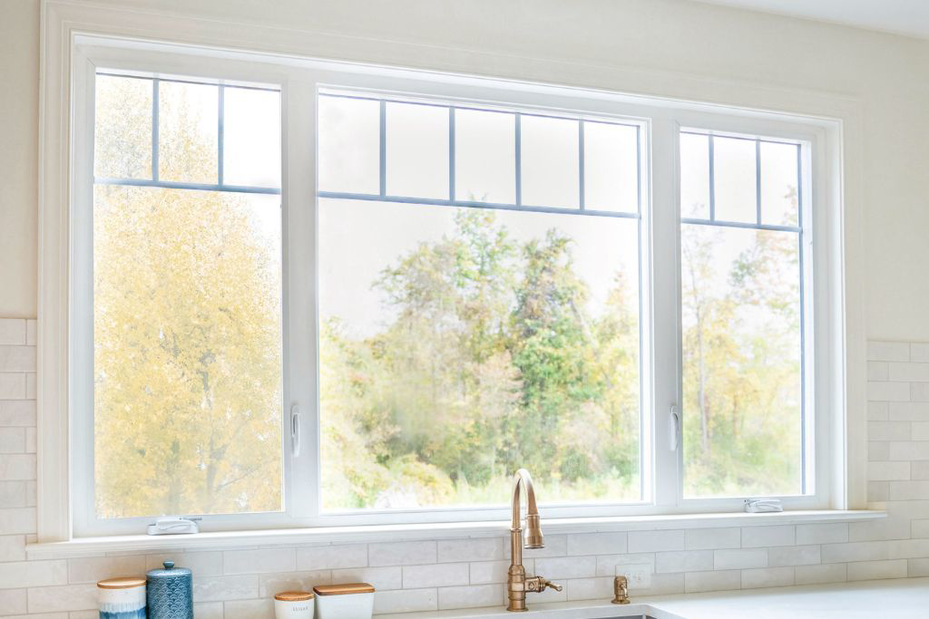 A newly installed kitchen window, sink, and white subway tile backsplash by Smucker & Sons Inc in Ephrata, PA.