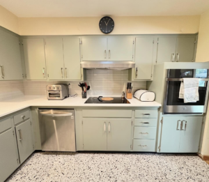Kitchen with light green cabinets, new white countertops, and subway tile backsplash by Cabinet Refinishing Northwest in Beaverton, OR.