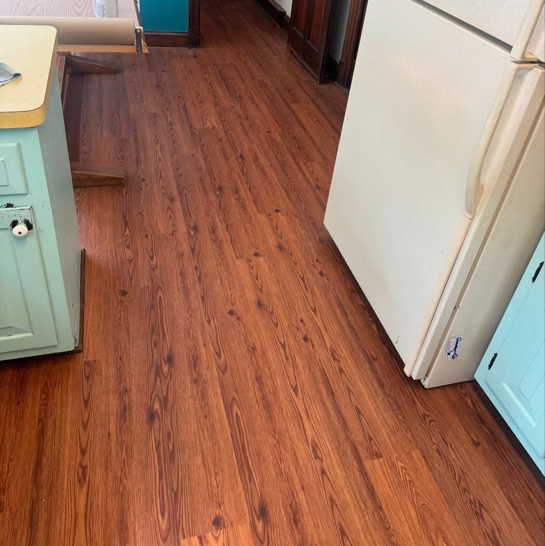 Kitchen with new wood-look flooring installed by Sanchez & Hall Construction in Richmond, VA.