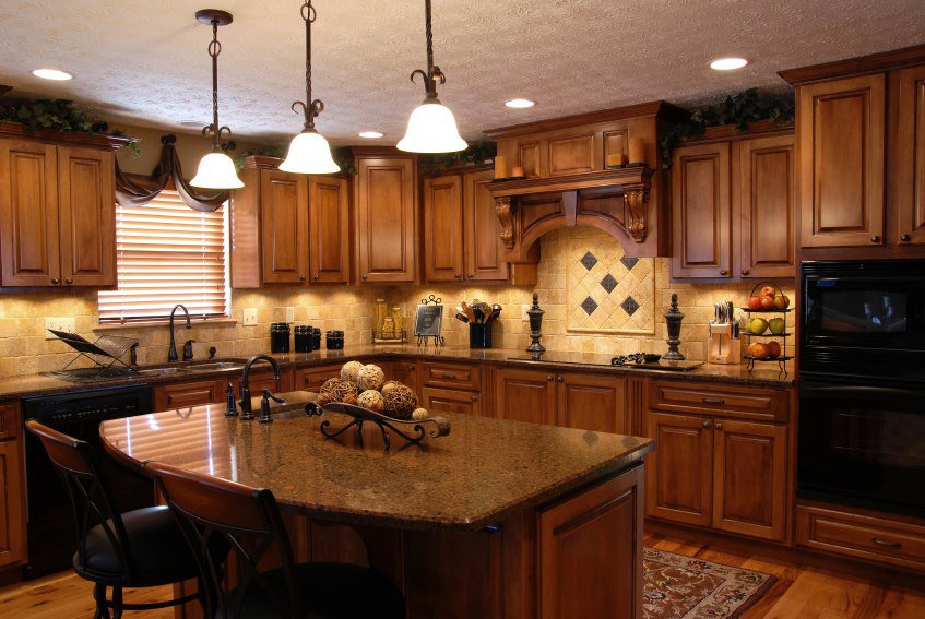 A kitchen with rich wooden cabinets, granite countertops, and a central island, demonstrating handyman expertise from Paradise Found Construction in Cary, NC.
