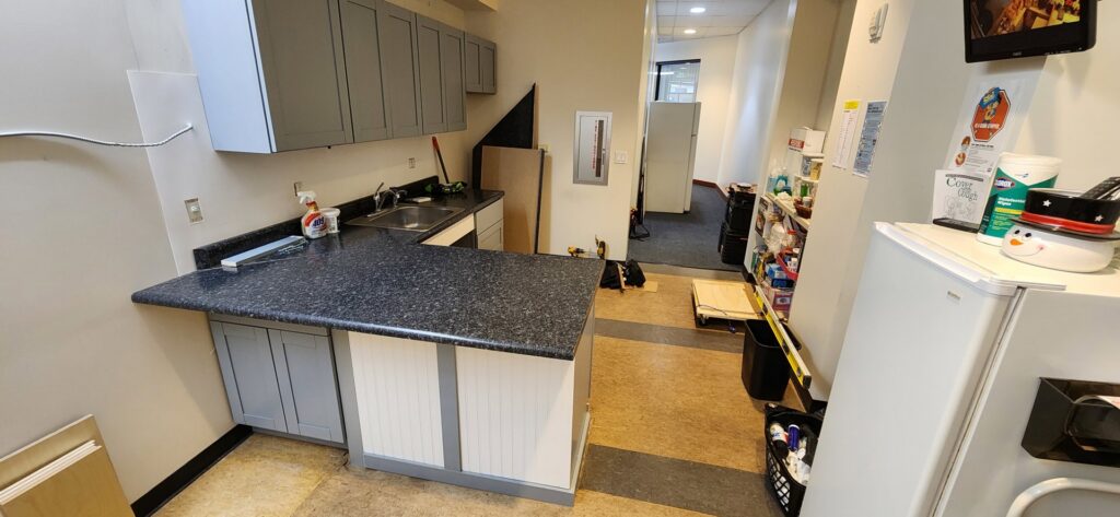 A completed kitchenette installation featuring grey cabinets and a dark countertop by Just-In-Time Handyman Services in Honolulu, HI.