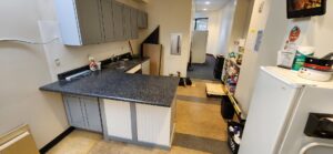 A completed kitchenette installation featuring grey cabinets and a dark countertop by Just-In-Time Handyman Services in Honolulu, HI.